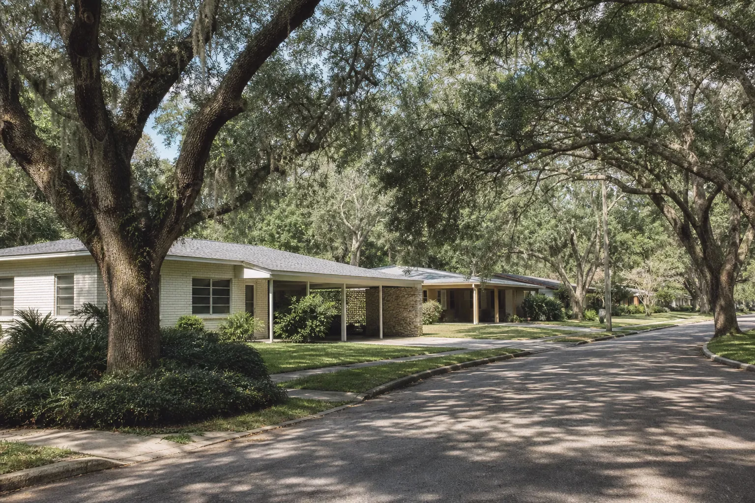 Quiet street of single-storey mid-century ranch homes under mature live oaks, Cedar Hills in west Jacksonville