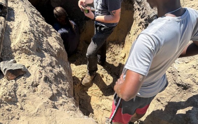 The Greatful Plumber technicians excavating and repairing an underground pipe leak in Jacksonville's sandy soil