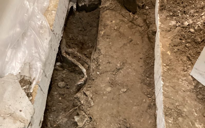 Major plumbing disaster requiring excavation and concrete removal in commercial building, showing the extensive damage and repair work needed for business continuity